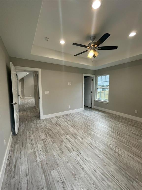 1315 West Gandy Street Denison, TX 75020 - Photo 14 of 19 a view of empty room with wooden floor and fan