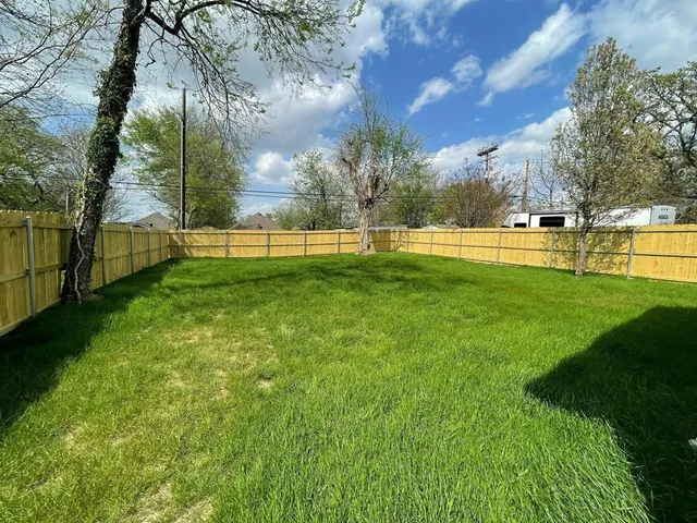 a view of yard with swimming pool and green space
