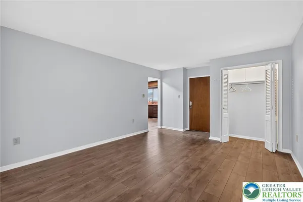 a view of an empty room with wooden floor