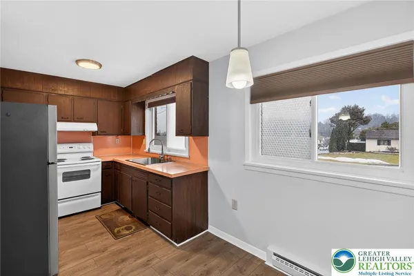a kitchen with stainless steel appliances a refrigerator and a stove