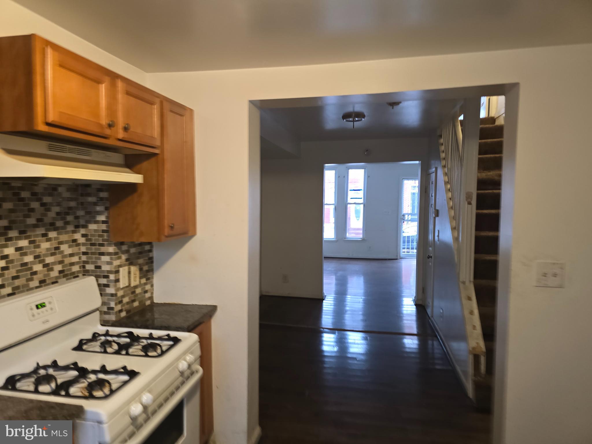 1121 Cleveland Street Baltimore, MD 21230 - Photo 6 of 13 a kitchen with a stove and a wooden cabinets
