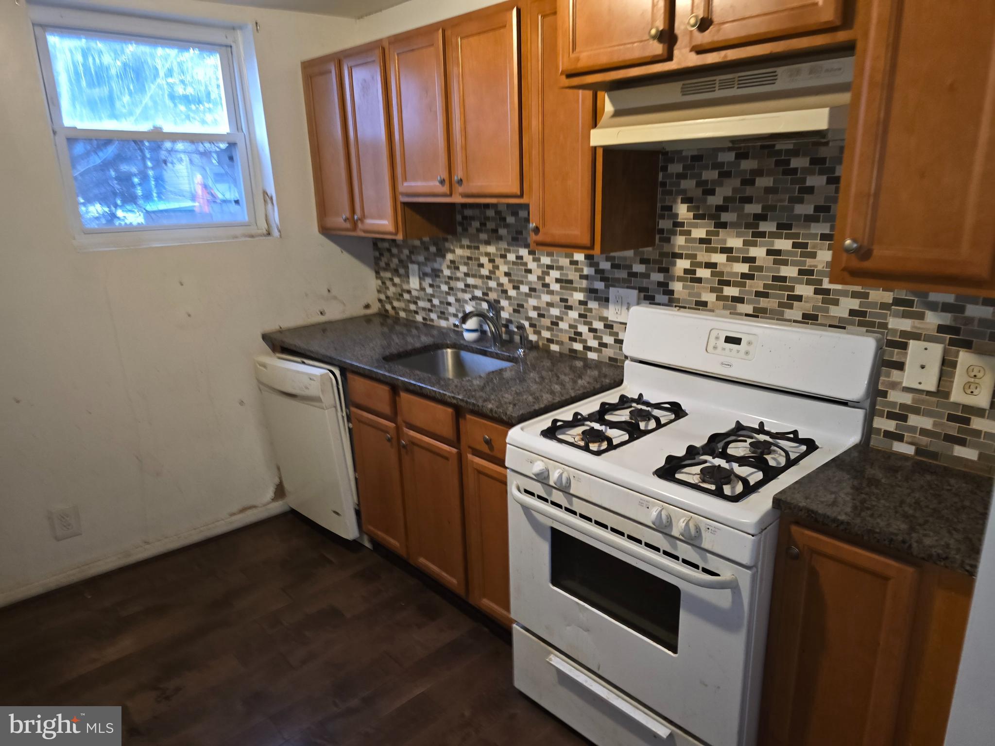 1121 Cleveland Street Baltimore, MD 21230 - Photo 7 of 13 a kitchen with granite countertop a stove and a sink