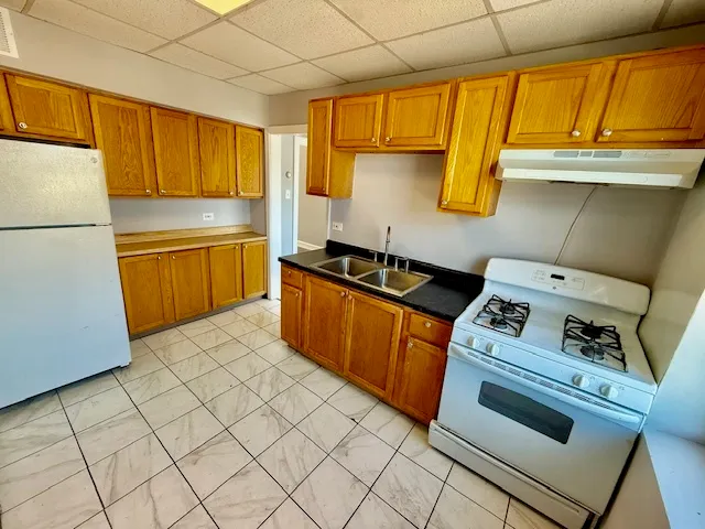 a kitchen with a stove a sink and a refrigerator