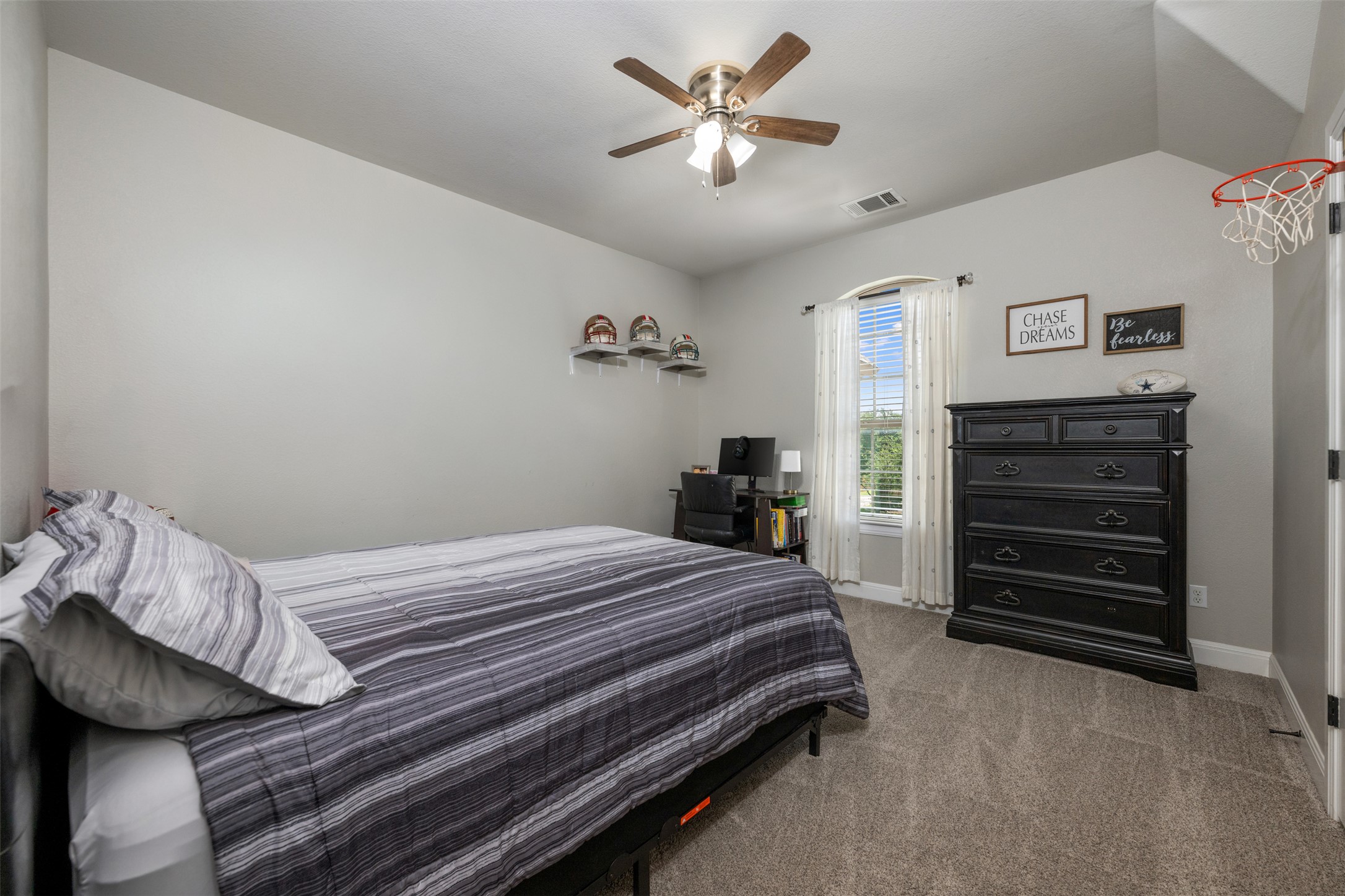 3021 Wedgescale Pass Leander, TX 78641 - Photo 21 of 40 a bedroom with a bed and a chandelier