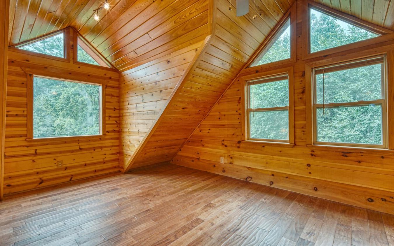 1666 Underwood Road Hiawassee, GA 30546 - Photo 25 of 42 a view of an empty room with wooden floor and a window