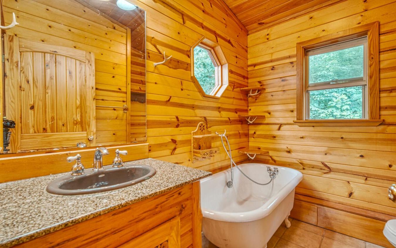 1666 Underwood Road Hiawassee, GA 30546 - Photo 28 of 42 a bathroom with a sink and a mirror
