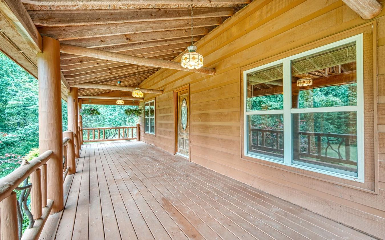 1666 Underwood Road Hiawassee, GA 30546 - Photo 32 of 42 a view of porch with wooden floor and a floor to ceiling window