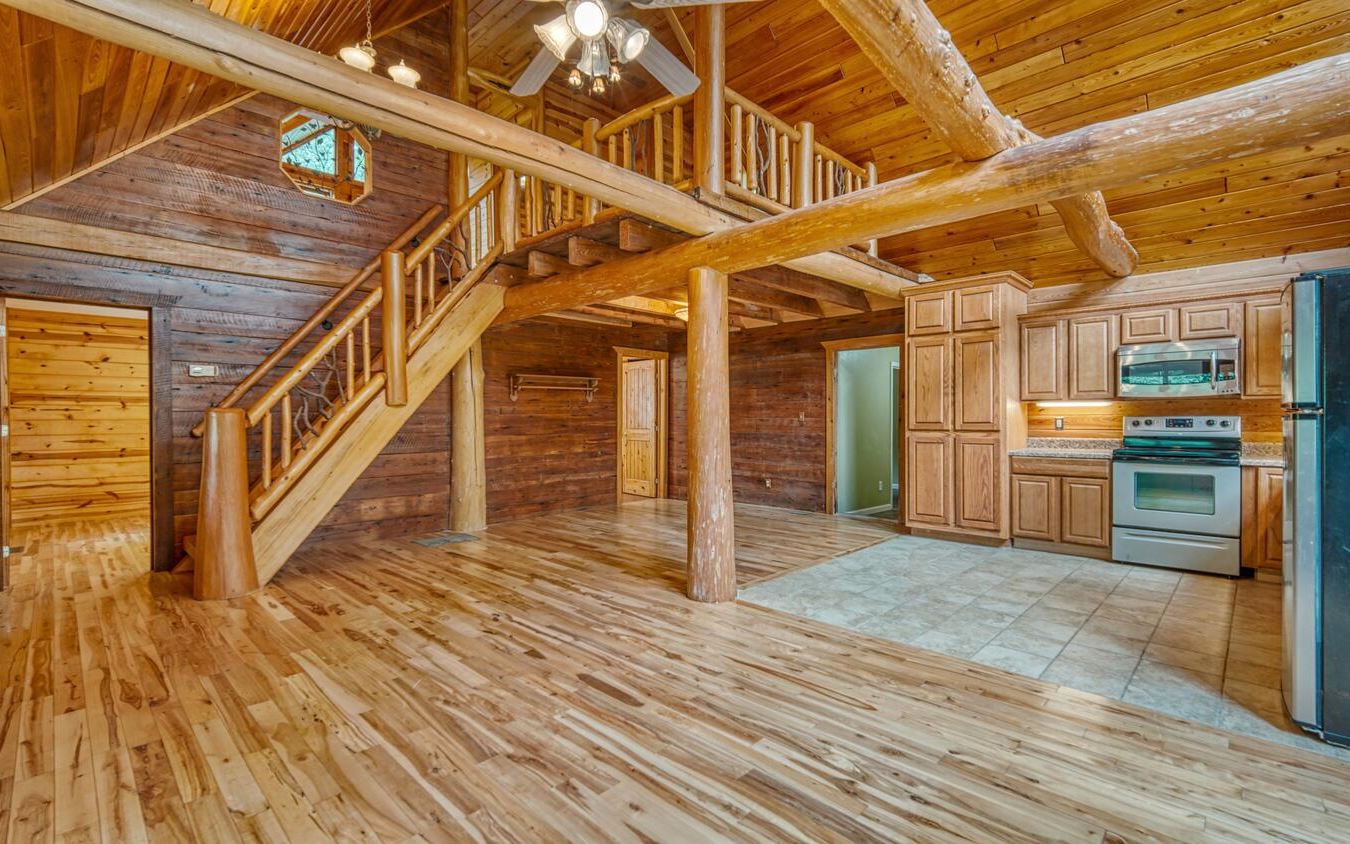 1666 Underwood Road Hiawassee, GA 30546 - Photo 6 of 42 a view of a hallway with wooden floors and kitchen