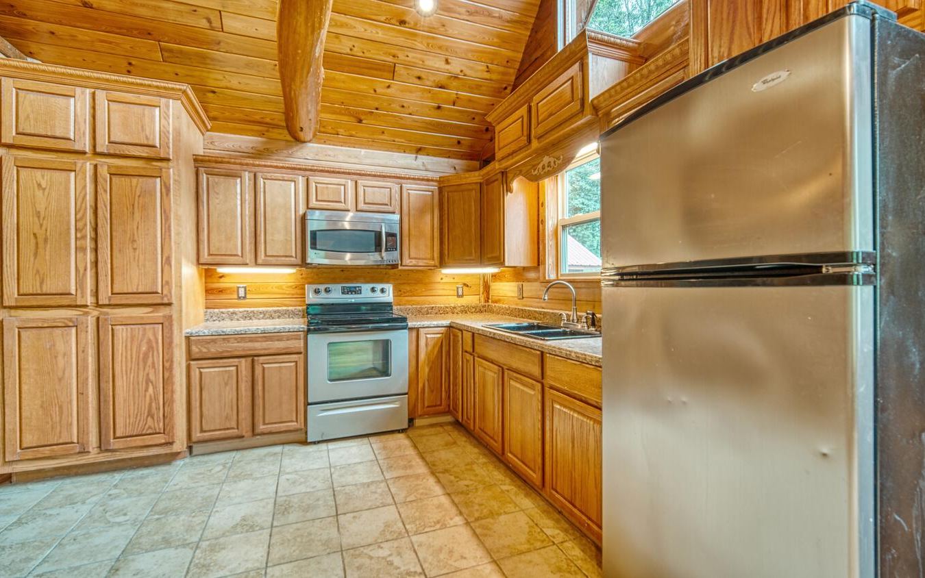 1666 Underwood Road Hiawassee, GA 30546 - Photo 10 of 42 a kitchen with stainless steel appliances granite countertop a refrigerator and a stove