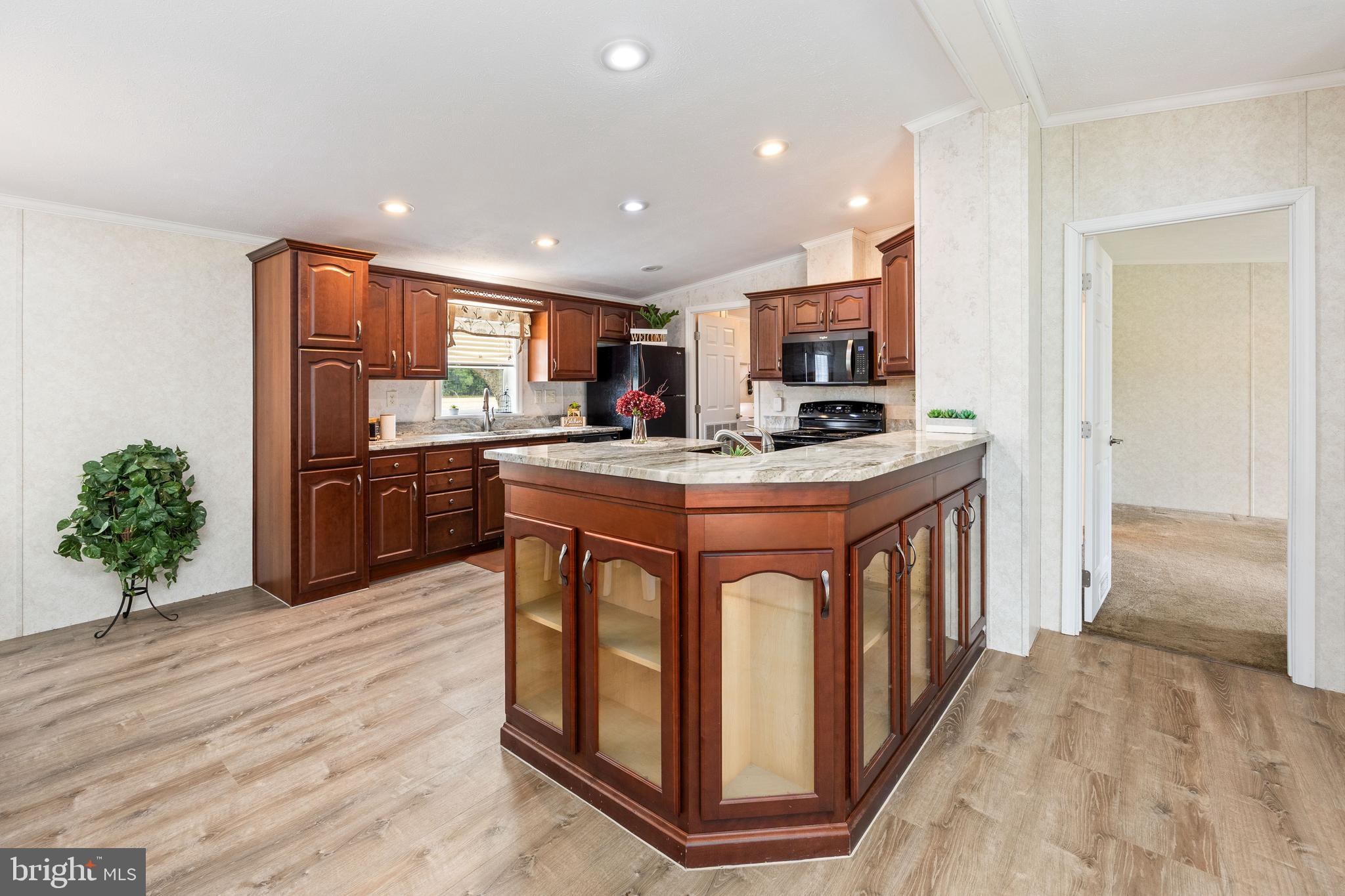 4258 Smith Road Salisbury, MD 21801 - Photo 27 of 43 a kitchen with stainless steel appliances granite countertop a stove a sink and a refrigerator