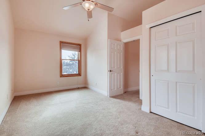 380 County Road Louisville, CO 80027 - Photo 14 of 28 an empty room with windows and chandelier fan