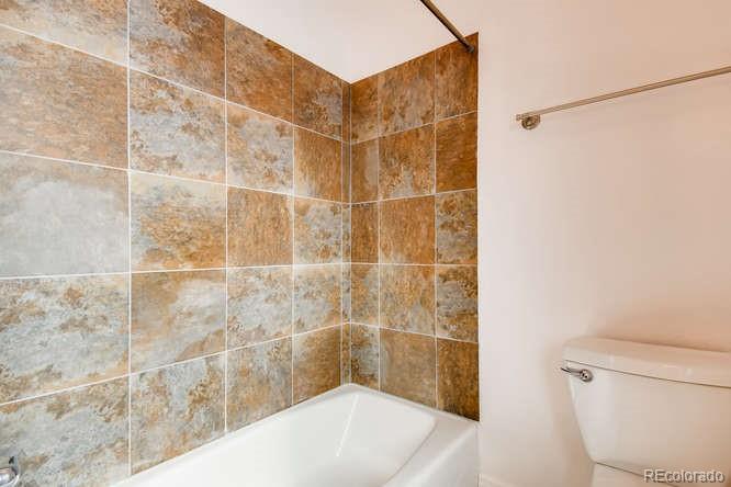 380 County Road Louisville, CO 80027 - Photo 17 of 28 a bathroom with a bathtub and a toilet