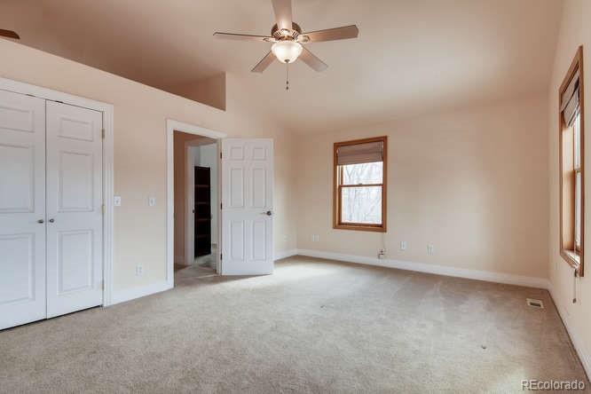 380 County Road Louisville, CO 80027 - Photo 19 of 28 an empty room with chandelier fan and windows
