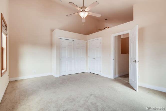 380 County Road Louisville, CO 80027 - Photo 20 of 28 an empty room with closet and a chandelier fan