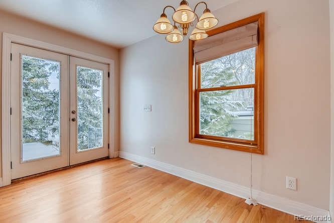 380 County Road Louisville, CO 80027 - Photo 7 of 28 a view of an empty room with wooden floor and a window