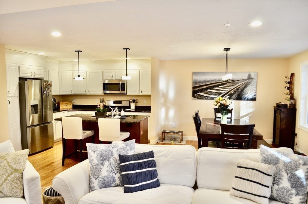 a living room with furniture and kitchen view