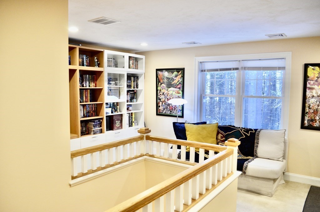 3 Trail Ridge Way, Unit D Harvard, MA 01451 - Photo 16 of 41 a living room with furniture and a book shelf