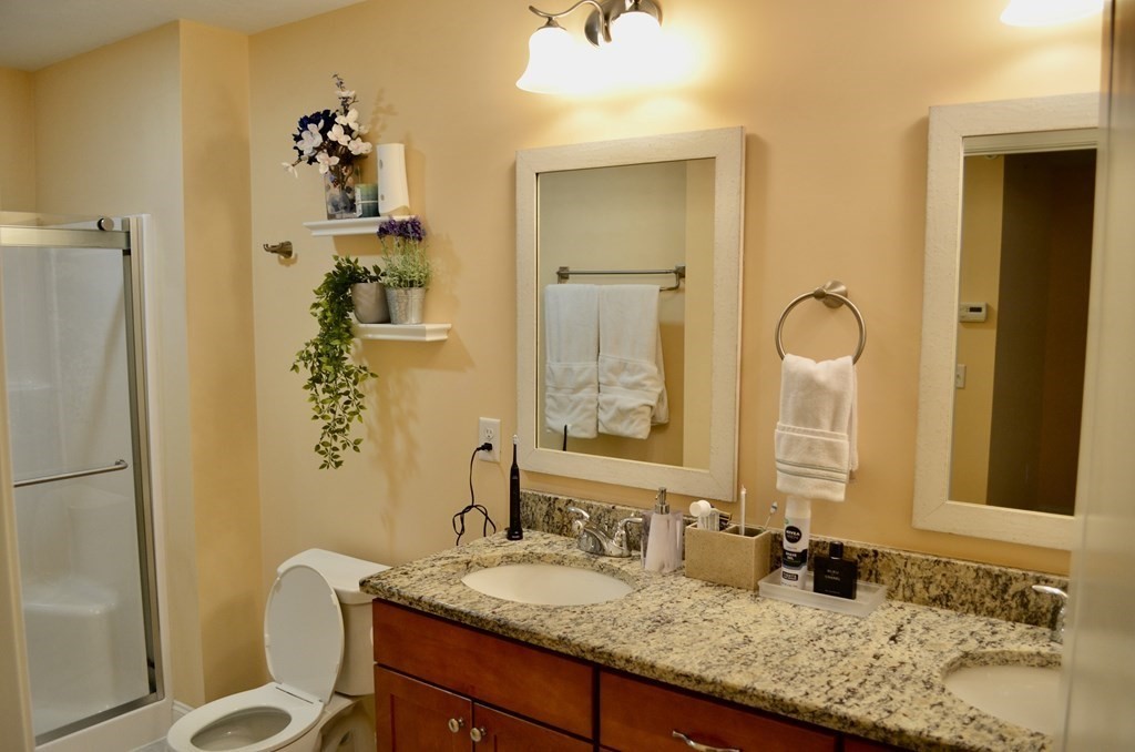 3 Trail Ridge Way, Unit D Harvard, MA 01451 - Photo 25 of 41 a bathroom with a granite countertop sink and a mirror
