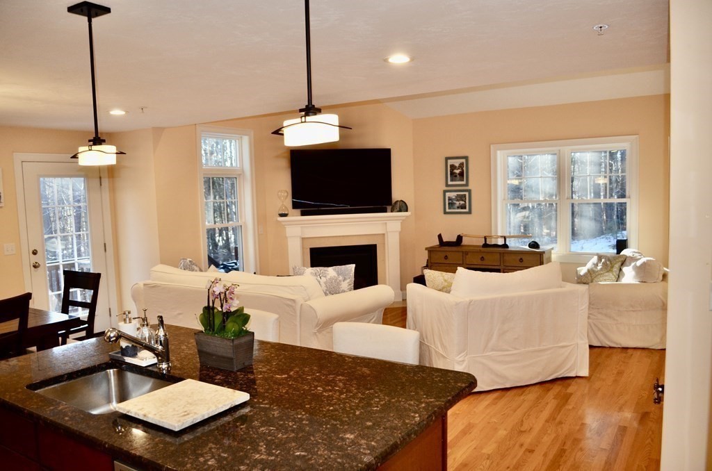 3 Trail Ridge Way, Unit D Harvard, MA 01451 - Photo 8 of 41 a living room with furniture a fireplace and a flat screen tv