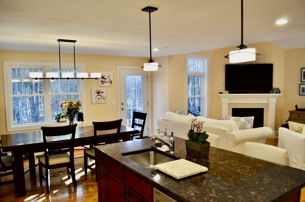 3 Trail Ridge Way, Unit D Harvard, MA 01451 - Photo 9 of 41 a living room with furniture a flat screen tv and a fireplace