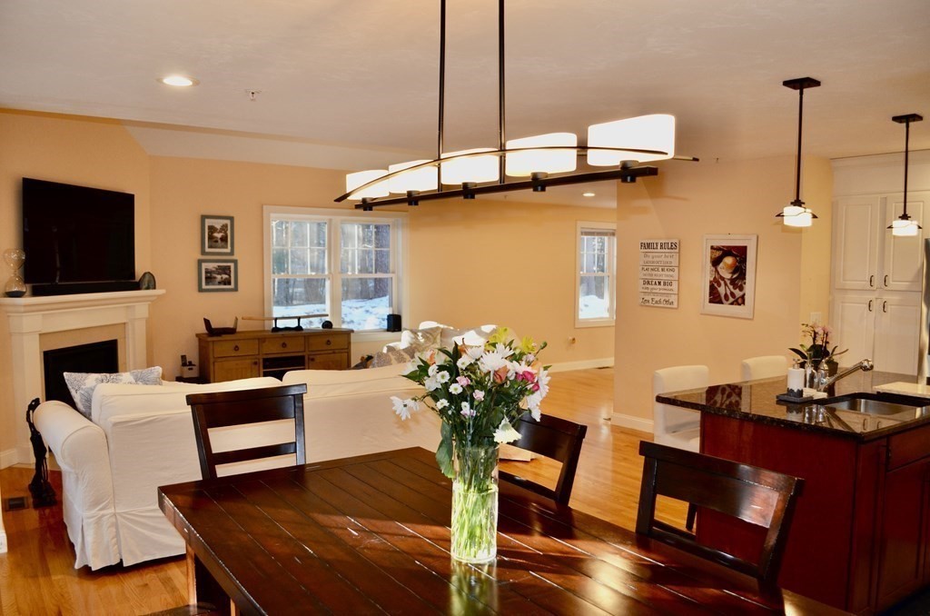 3 Trail Ridge Way, Unit D Harvard, MA 01451 - Photo 10 of 41 a living room with furniture a flat screen tv and a chandelier