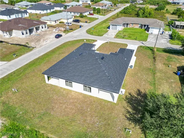 an aerial view of a house with a swimming pool