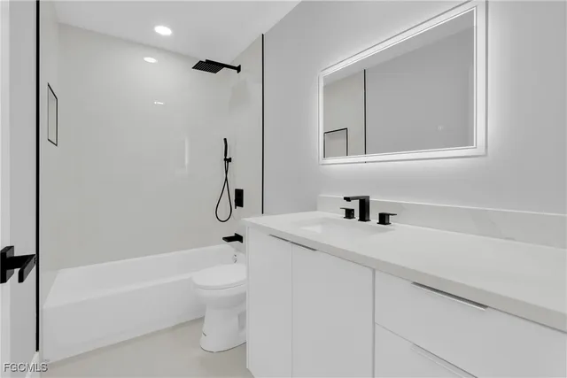 a bathroom with a sink a toilet and a bathtub