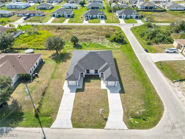 an aerial view of a house with a garden and lake view