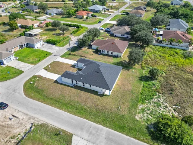 an aerial view of a house with a garden and swimming pool