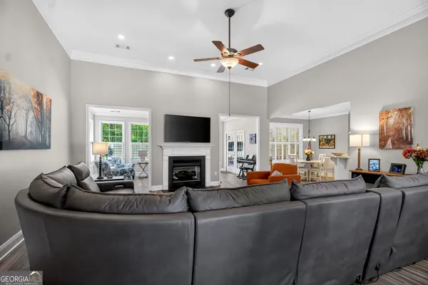 a living room with fireplace furniture and a flat screen tv
