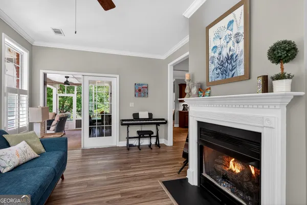 a kitchen with stainless steel appliances granite countertop a sink a stove and chairs