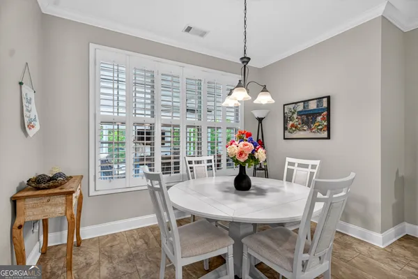 a kitchen with stainless steel appliances a sink a stove a refrigerator cabinets and a window