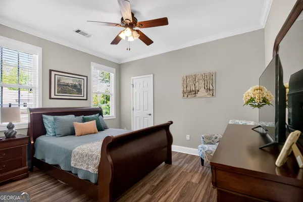 a bedroom with a bed window and couch