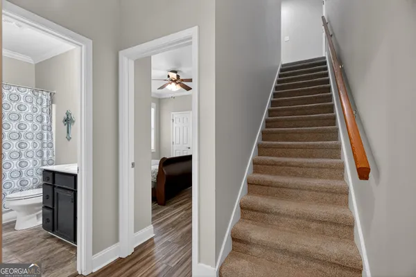 a bedroom with a bed a couch and a window