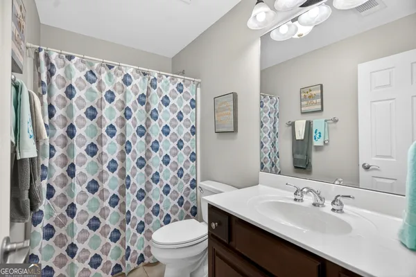 a bathroom with a toilet and a bathtub