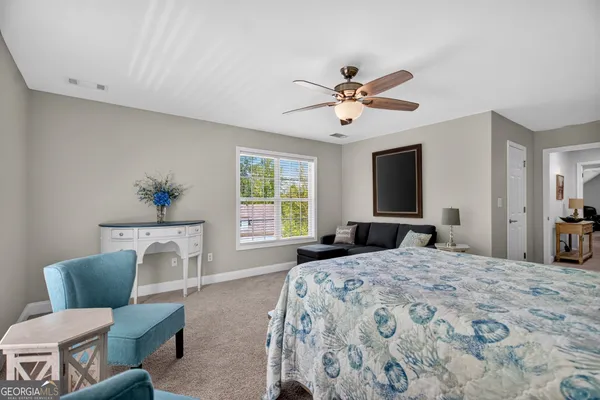 a living room with furniture fireplace and a large window