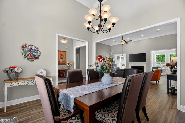 a view of a dining room with furniture wooden floor and chandelier