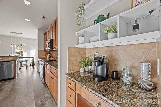 a living room with furniture and a ceiling fan