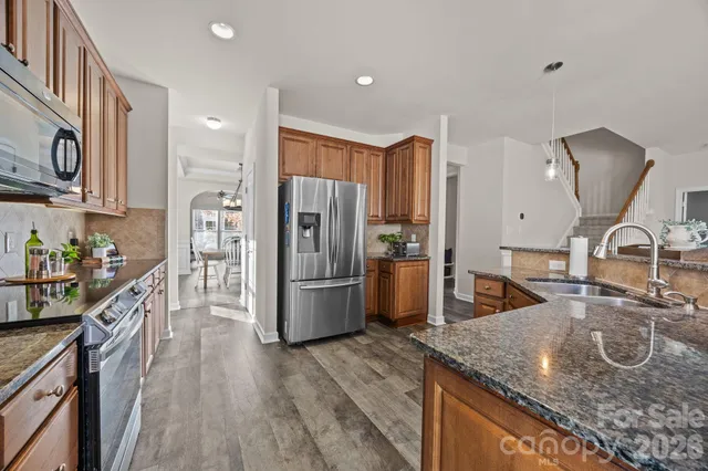 a spacious bedroom with a bed and a tv