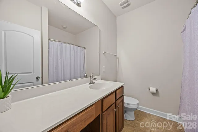 a view of a tree in front of a house