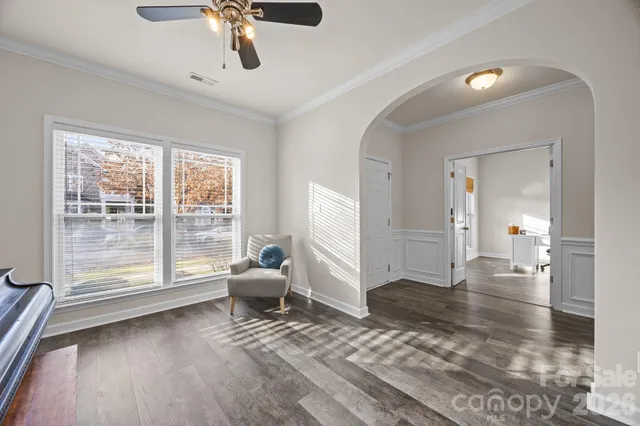 a kitchen with stainless steel appliances granite countertop a sink a stove top oven and wooden floors