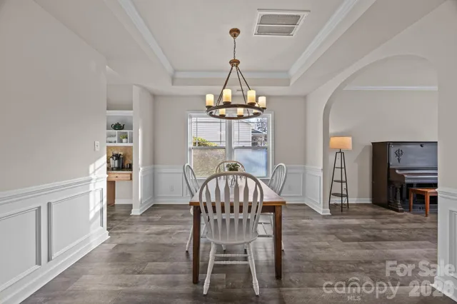 a view of a dining room with furniture and chandelier