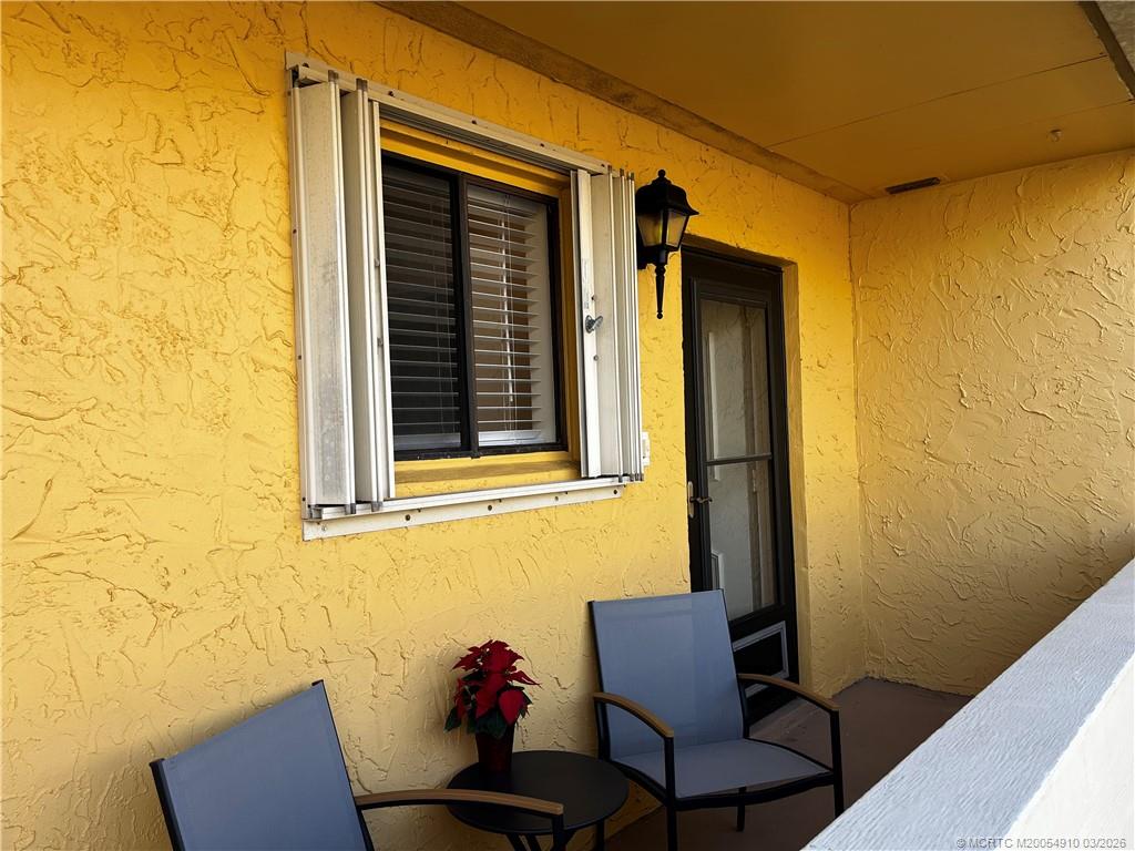 5323 Southeast Miles Grant Road, Unit 206 Stuart, FL 34997 - Photo 3 of 20 a view of a door and chair in the front of a door