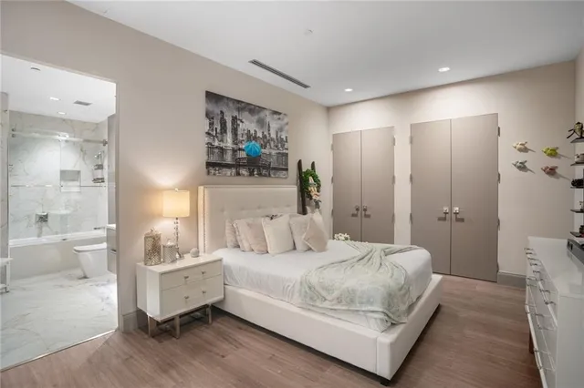 a bedroom with a bed and a large mirror