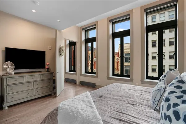 a bedroom with a bed and glass windows