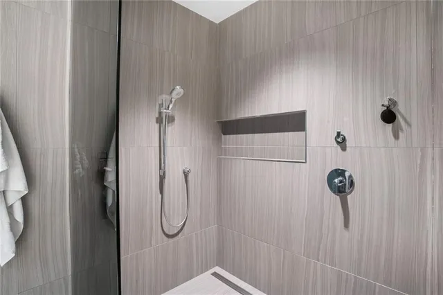 a bathroom with a glass shower door