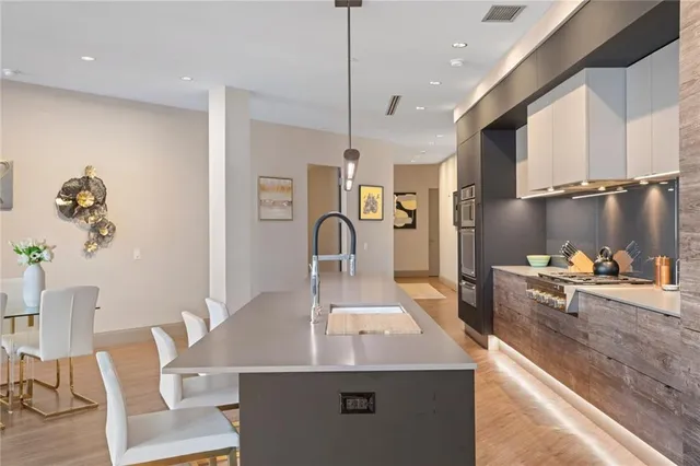 a kitchen with a table chairs and a refrigerator
