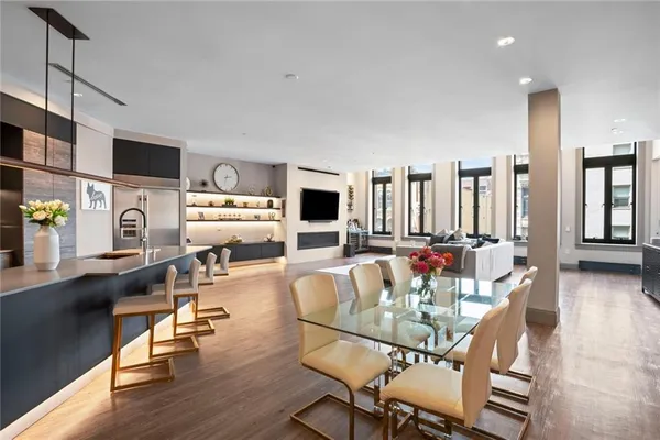 a dining room with furniture and wooden floor