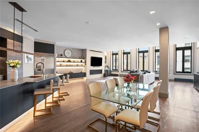 a dining room with furniture and wooden floor