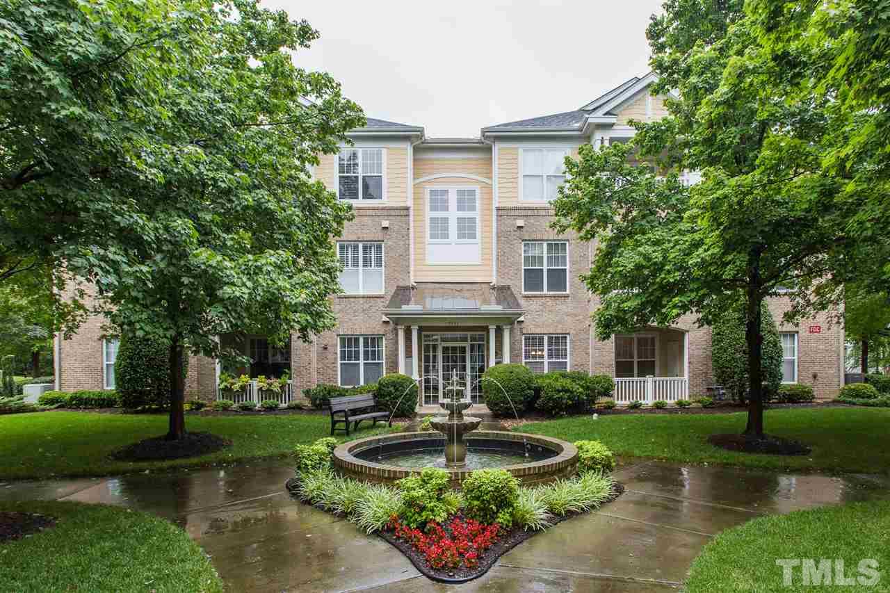 3151 Hemlock Forest Circle, Unit 102 Raleigh, NC 27612 - Photo 1 of 26 a front view of a house with garden and trees